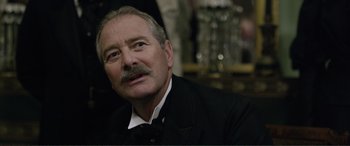 Movie still from “Victoria & Abdul” (2017), directed by Stephen Frears – An older man wearing a suit and a mustache; Close Up shot, Over the shoulder angle