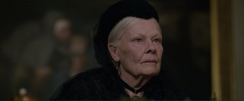 Movie still from “Victoria & Abdul” (2017), directed by Stephen Frears – An older woman wearing a black hat and a black dress; Close Up shot, Over the shoulder angle