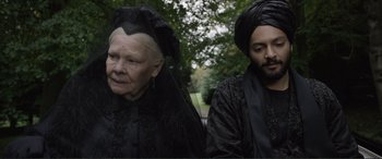 Movie still from “Victoria & Abdul” (2017), directed by Stephen Frears – A man and a woman dressed up in black; Medium shot, Over the shoulder angle