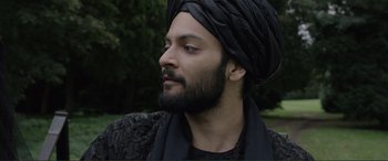 Movie still from “Victoria & Abdul” (2017), directed by Stephen Frears – A man with a beard wearing a turban; Close Up shot, Over the shoulder angle