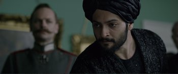 Movie still from “Victoria & Abdul” (2017), directed by Stephen Frears – A man with a beard wearing a black turban; Close Up shot, Over the shoulder angle