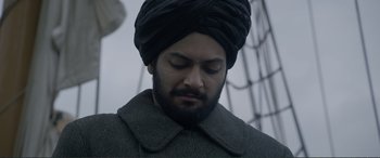 Movie still from “Victoria & Abdul” (2017), directed by Stephen Frears – A man with a turban on his head is looking down; Close Up shot, Low angle