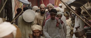 Movie still from “Victoria & Abdul” (2017), directed by Stephen Frears – A group of men wearing turbans walking down a street; Wide shot, Low angle