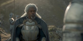 Movie still from “House of the Dragon” (2022), created by George R.R. Martin – A man in a suit of armor with a long white beard; Close Up shot, Over the shoulder angle