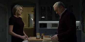Movie still from “House of Cards” (2013), created by Beau Willimon – A man and a woman preparing food on a cutting board; Medium shot, Over the shoulder angle