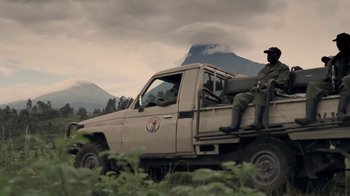 A man sitting in the back of a pick - up truck