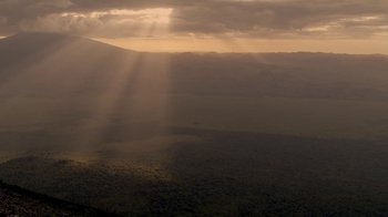 The sun is shining through the clouds on a cloudy day