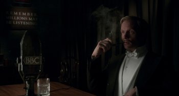 Movie still from “Vita & Virginia” (2018), directed by Chanya Button – A man in a tuxedo is smoking a cigarette; Close Up shot, High angle