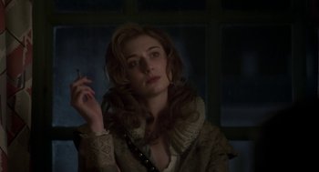 Movie still from “Vita & Virginia” (2018), directed by Chanya Button – A woman is holding a cigarette in her hand; Close Up shot, Over the shoulder angle