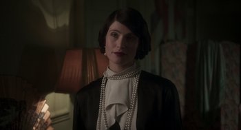 Movie still from “Vita & Virginia” (2018), directed by Chanya Button – A woman in a black jacket and a white blouse; Close Up shot, Over the shoulder angle