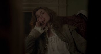 Movie still from “Vita & Virginia” (2018), directed by Chanya Button – A woman in a white shirt and a brown jacket; Close Up shot, Over the shoulder angle