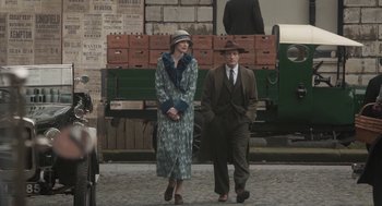 Movie still from “Vita & Virginia” (2018), directed by Chanya Button – A man and a woman walking down a street; Wide shot, Over the shoulder angle