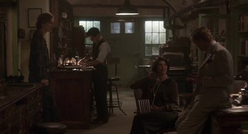 Movie still from “Vita & Virginia” (2018), directed by Chanya Button – A man and a woman sitting in chairs in a room; Wide shot, High angle