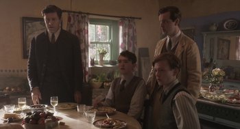 Movie still from “Vita & Virginia” (2018), directed by Chanya Button – A group of people sitting at a table with food; Medium shot, Low angle