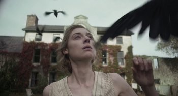 Movie still from “Vita & Virginia” (2018), directed by Chanya Button – A woman looking up at a bird flying in the air; Close Up shot, Low angle