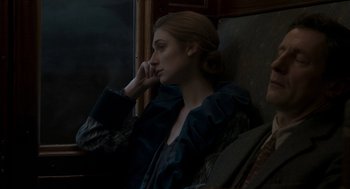 Movie still from “Vita & Virginia” (2018), directed by Chanya Button – A woman sitting in a chair with her head resting on her hand; Close Up shot, High angle