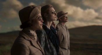 Movie still from “Vita & Virginia” (2018), directed by Chanya Button – A group of people standing next to each other; Medium shot, Low angle