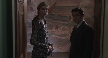 Movie still from “Vita & Virginia” (2018), directed by Chanya Button – A man and a woman standing next to each other in a room; Medium shot, Low angle