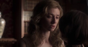 Movie still from “Vita & Virginia” (2018), directed by Chanya Button – A woman with long blonde curly hair looking to her left; Close Up shot, Over the shoulder angle