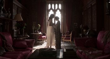 Movie still from “Vita & Virginia” (2018), directed by Chanya Button – Two women standing in front of a window in a living room; Wide shot, Low angle