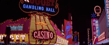 Movie still from “Viva Las Vegas” (1964), directed by George Sidney – The neon lights of a casino are lit up at night; Extreme Wide shot, High angle