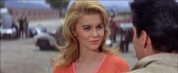 Movie still from “Viva Las Vegas” (1964), directed by George Sidney – A beautiful woman with blonde hair wearing an orange shirt; Close Up shot, Low angle