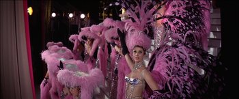 Movie still from “Viva Las Vegas” (1964), directed by George Sidney – A group of women dressed up in pink feathers and sequins; Medium shot, High angle