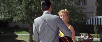 Movie still from “Viva Las Vegas” (1964), directed by George Sidney – A man and a woman are holding a guitar; Medium shot, Over the shoulder angle