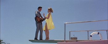 Movie still from “Viva Las Vegas” (1964), directed by George Sidney – A man and a woman standing next to each other; Wide shot, Low angle