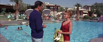 Movie still from “Viva Las Vegas” (1964), directed by George Sidney – A man and a woman standing in a swimming pool; Medium shot, Over the shoulder angle