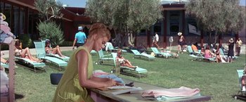 Movie still from “Viva Las Vegas” (1964), directed by George Sidney – A woman sitting at a table writing on a piece of paper; Medium shot, High angle