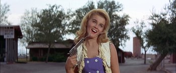 Movie still from “Viva Las Vegas” (1964), directed by George Sidney – A woman holding a gun in her mouth; Medium shot, Low angle