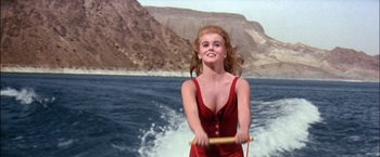 Movie still from “Viva Las Vegas” (1964), directed by George Sidney – A woman in a red bathing suit holding a paddle; Medium shot, High angle