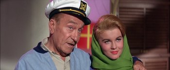 Movie still from “Viva Las Vegas” (1964), directed by George Sidney – An older man and a younger woman posing for a picture; Close Up shot, Low angle