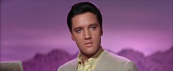 Movie still from “Viva Las Vegas” (1964), directed by George Sidney – A person wearing a suit and tie; Close Up shot, Low angle