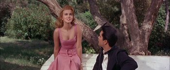 Movie still from “Viva Las Vegas” (1964), directed by George Sidney – A man and a woman sitting next to each other on a park bench; Medium shot, Over the shoulder angle