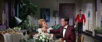 Movie still from “Viva Las Vegas” (1964), directed by George Sidney – A man and a woman in formal wear at a dinner table; Medium shot, Over the shoulder angle