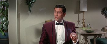 Movie still from “Viva Las Vegas” (1964), directed by George Sidney – A person wearing a suit and tie; Medium shot, Low angle