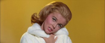 Movie still from “Viva Las Vegas” (1964), directed by George Sidney – A beautiful woman with long blonde hair wearing a white coat; Close Up shot, Low angle