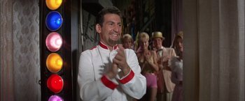 Movie still from “Viva Las Vegas” (1964), directed by George Sidney – A man in a chef's outfit clapping in front of a group of people; Medium shot, Low angle