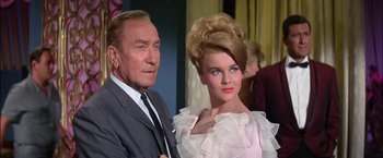 Movie still from “Viva Las Vegas” (1964), directed by George Sidney – An older man standing next to an older woman; Medium shot, Low angle