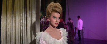 Movie still from “Viva Las Vegas” (1964), directed by George Sidney – A woman in a white dress with a big hair updo; Close Up shot, Low angle