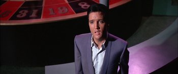 Movie still from “Viva Las Vegas” (1964), directed by George Sidney – A person wearing a suit and tie; Close Up shot, Low angle