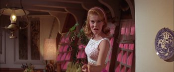 Movie still from “Viva Las Vegas” (1964), directed by George Sidney – A beautiful young lady in a white dress; Medium shot, Low angle