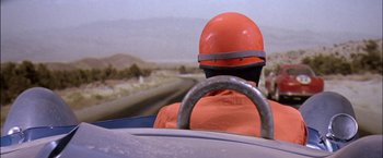Movie still from “Viva Las Vegas” (1964), directed by George Sidney – A person wearing a helmet driving in a car; Close Up shot, Low angle