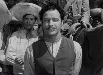Movie still from “Viva Zapata!” (1952), directed by Elia Kazan – Black and white photograph of a man with a mustache; Medium shot, Low angle