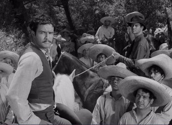 Movie still from “Viva Zapata!” (1952), directed by Elia Kazan – A black and white photo of a group of men on horseback; Medium shot, High angle