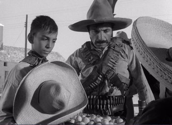 Movie still from “Viva Zapata!” (1952), directed by Elia Kazan – A man and a boy wearing cowboy hats; Medium shot, Low angle