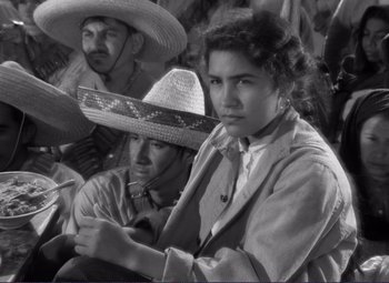 Movie still from “Viva Zapata!” (1952), directed by Elia Kazan – A group of people sitting next to each other wearing hats; Medium shot, High angle