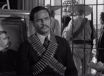 Movie still from “Viva Zapata!” (1952), directed by Elia Kazan – A black and white photo of a man in a suit and tie; Medium shot, Low angle